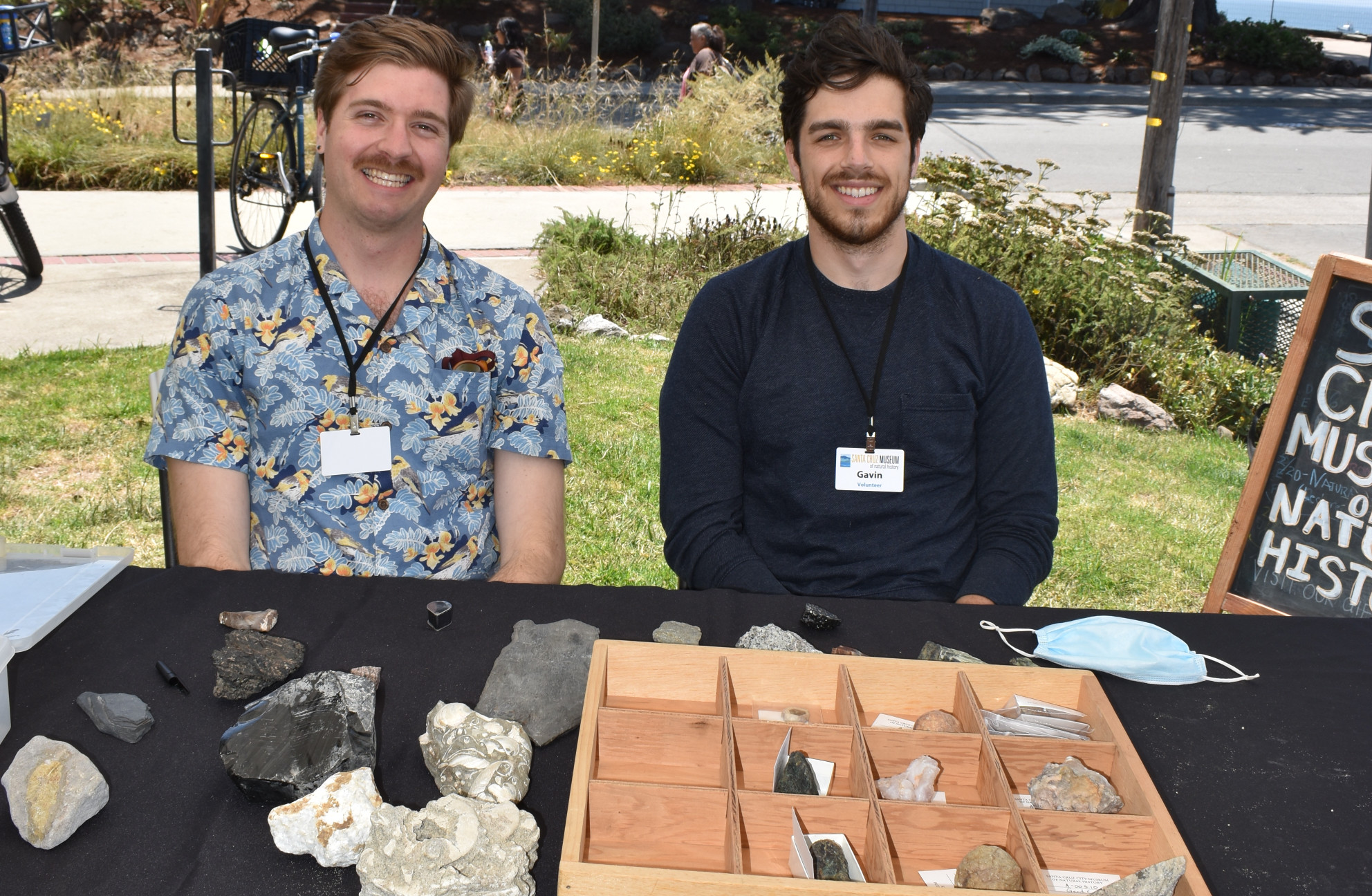 Graham and Gavin smiling while sitting at a table covered in rocks